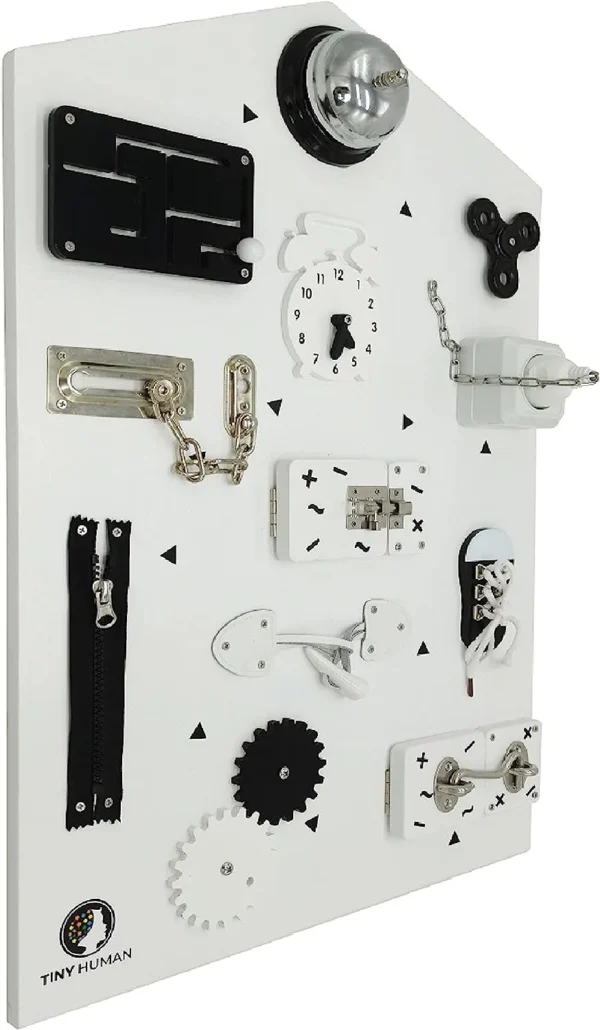 Montessori Learning Toy. Large white board with various interactive fixings such as locks, zips and switches.