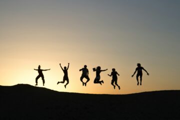 Children jumping in sunset